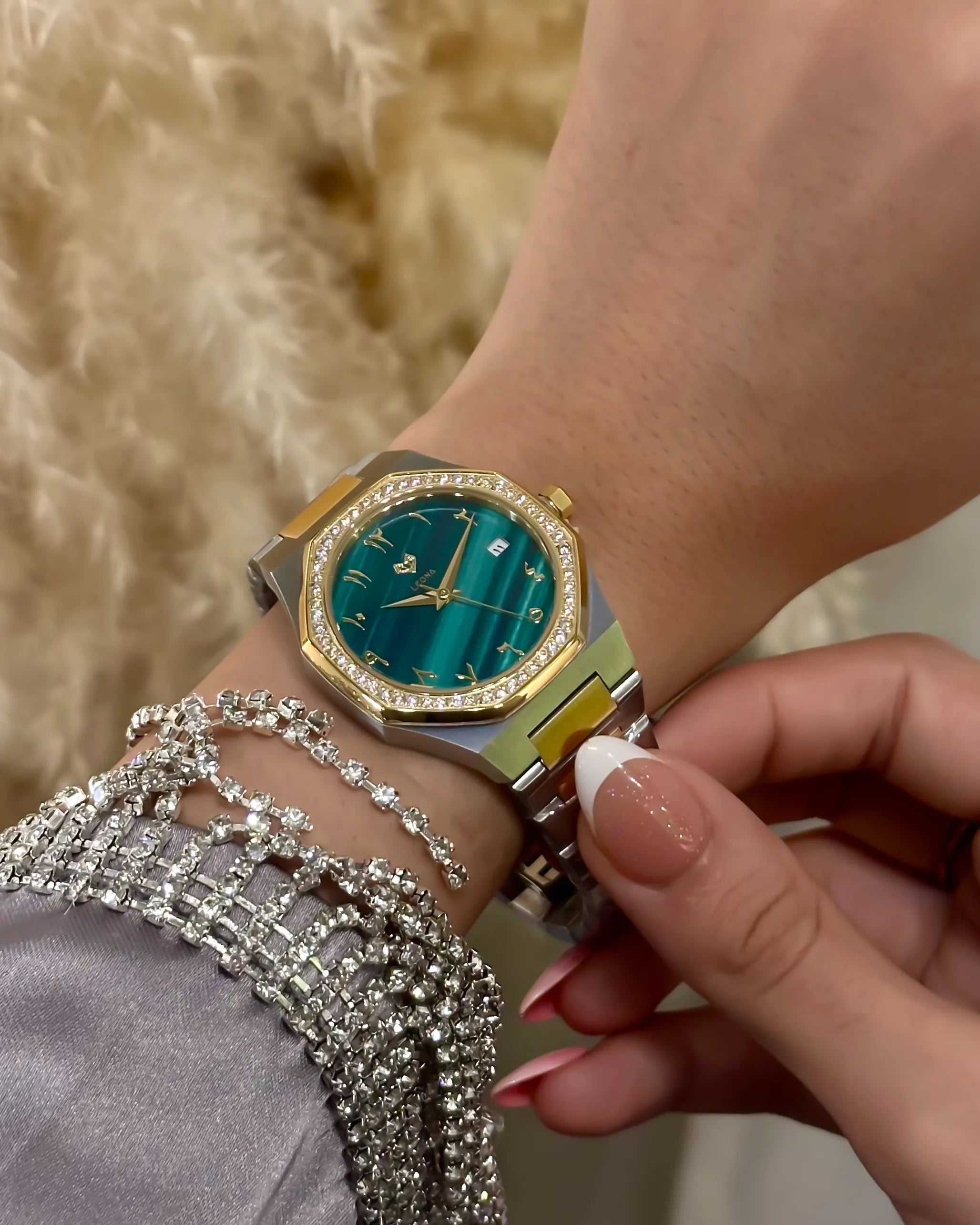 Close-up of a hand wearing a luxurious watch with a textured background