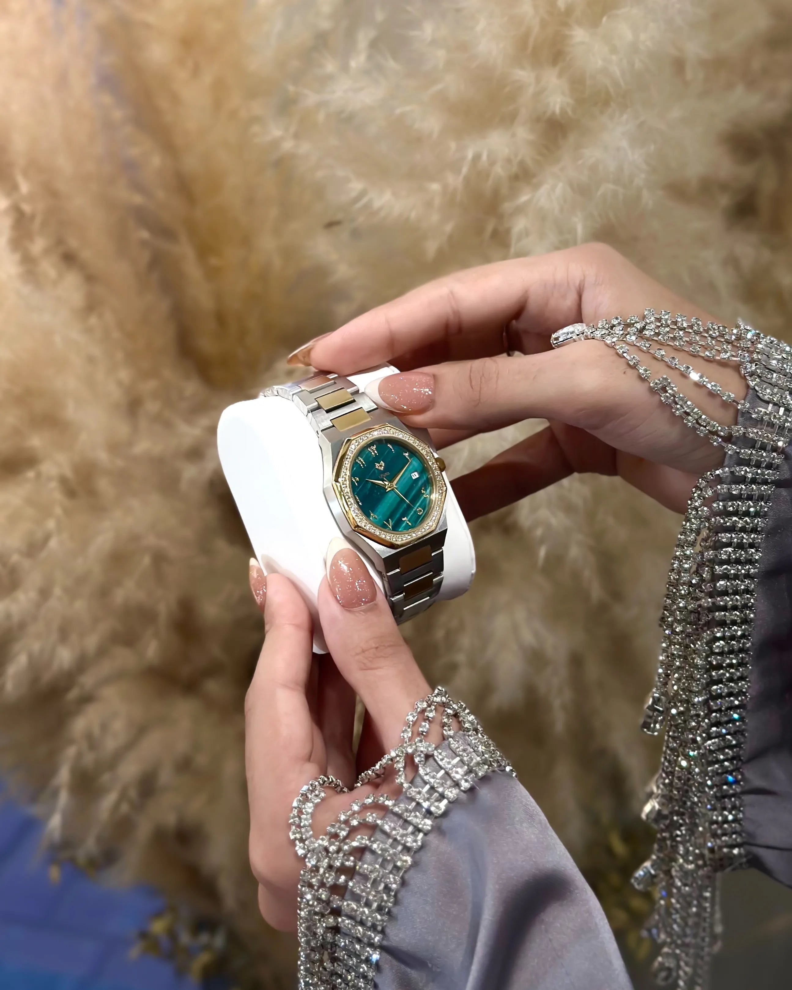 Hand holding a watch with a decorative background