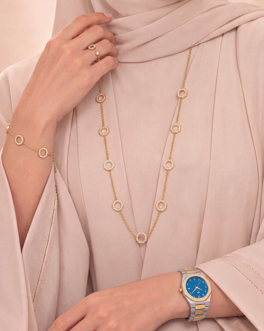 The Marquise Blue set worn with a beige abaya: octagon necklace, bracelet, ring and the Marquise Blue watch