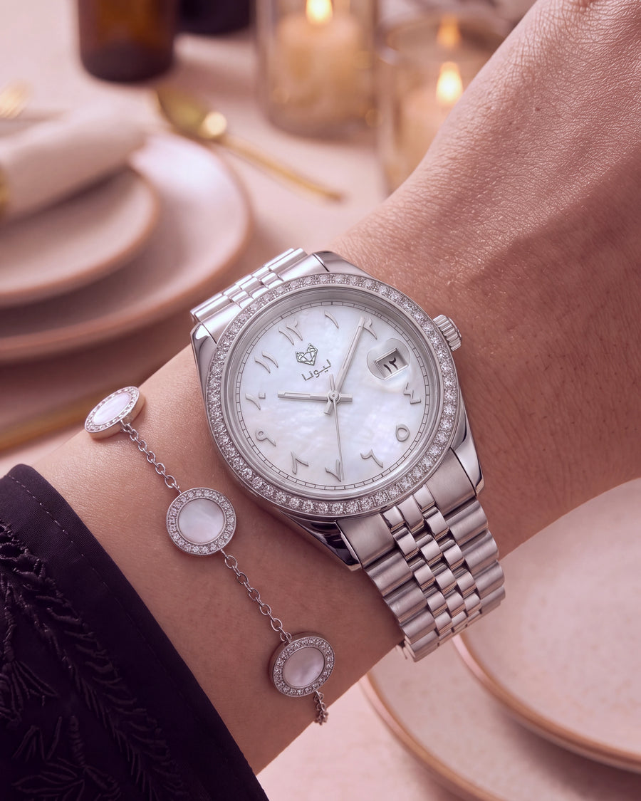 Perla White mother-of-pearl dial with Arabic numerals and the matching bracelet at an evening dinner