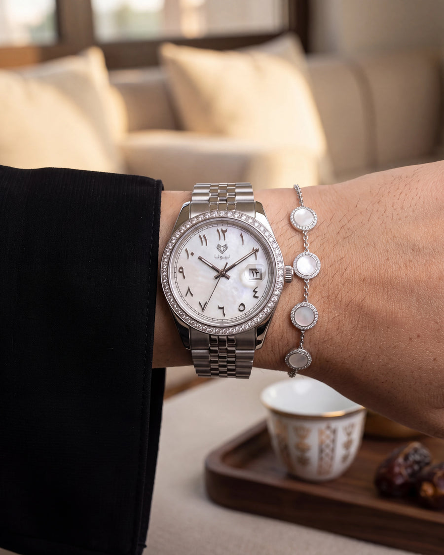Perla White watch and bracelet in a majlis beside Arabic coffee
